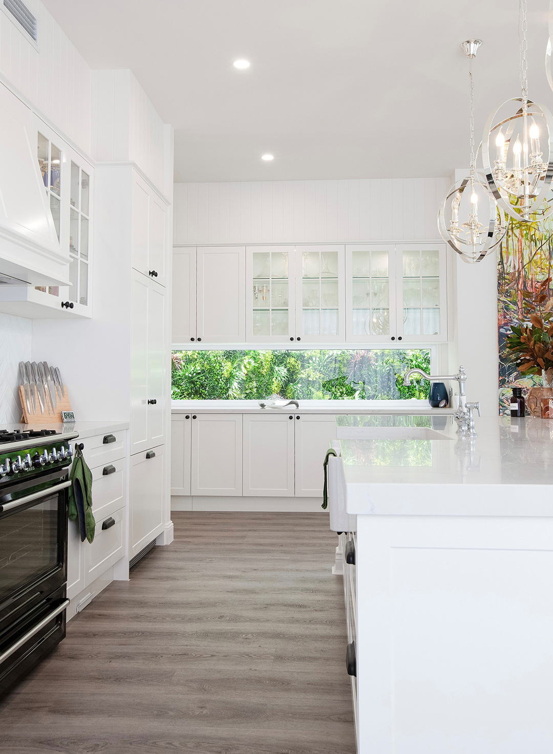 Queenslander-style kitchen in Brisbane with timber flooring and custom cabinetry in a soft neutral palette