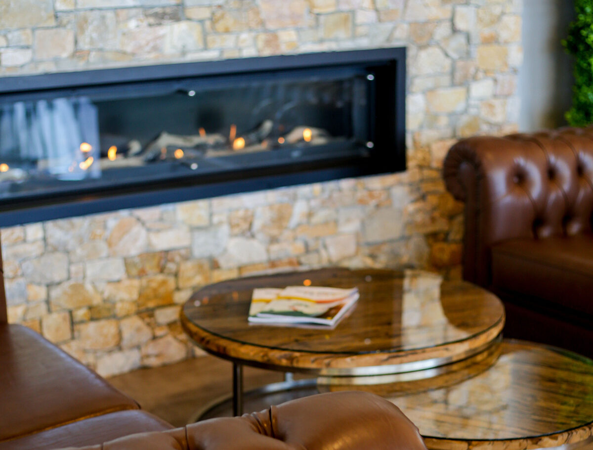 Interior design ideas for Melbourne heritage homes – Chesterfield sofas and stone fireplace in a period-style living room