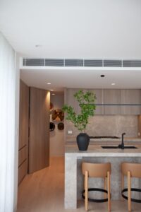 Custom kitchen design with marble benchtops and natural wood details in Kew, Melbourne